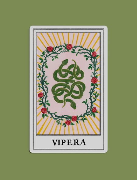 A stylized illustrated tarot card print created for Kindred Lubeck of Artifex Fine Jewelry. Tarot design features a green serpent coiled in the center, surrounded by a wreath of nine roses and thorns, with yellow sunburst rays and the word 'VIPERA'. Collaboration of Kindred Lubeck and Tess Ramirez