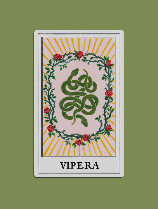 A stylized illustrated tarot card print created for Kindred Lubeck of Artifex Fine Jewelry. Tarot design features a green serpent coiled in the center, surrounded by a wreath of nine roses and thorns, with yellow sunburst rays and the word 'VIPERA'. Collaboration of Kindred Lubeck and Tess Ramirez