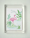 Closer view of framed Colony Hotel flamingo painting and tropical foliage