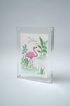 Colony Hotel flamingo painting standing upright in an acrylic frame