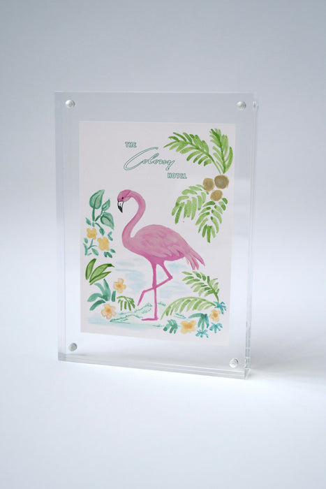 Colony Hotel flamingo painting standing upright in an acrylic frame