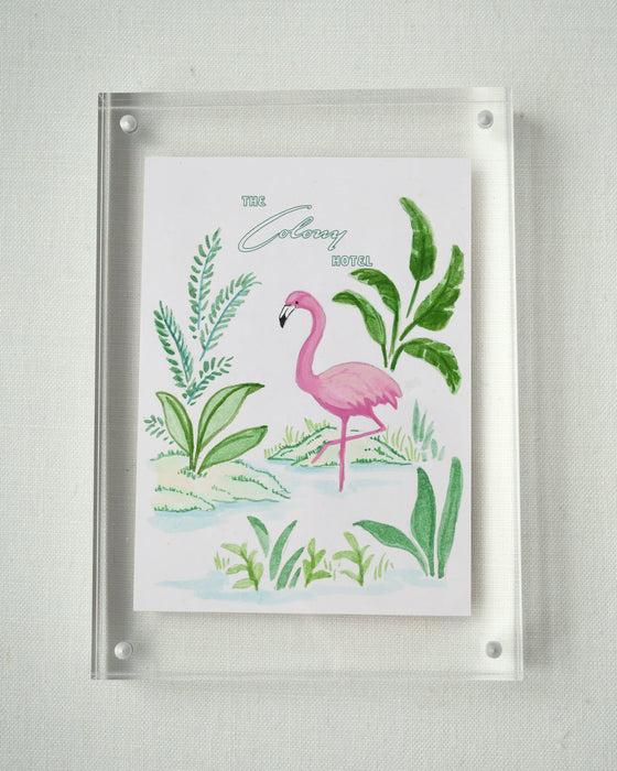 Colony Hotel flamingo and tropical foliage painting in a clear acrylic block frame