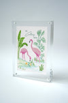 Colony Hotel flamingo painting standing upright in an acrylic frame