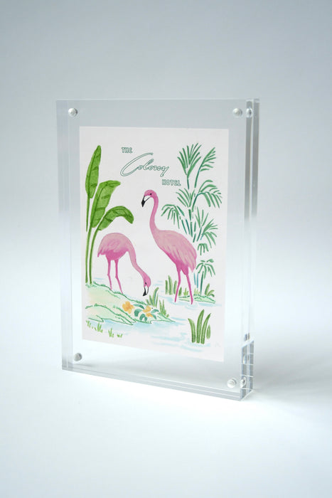 Colony Hotel flamingo painting standing upright in an acrylic frame